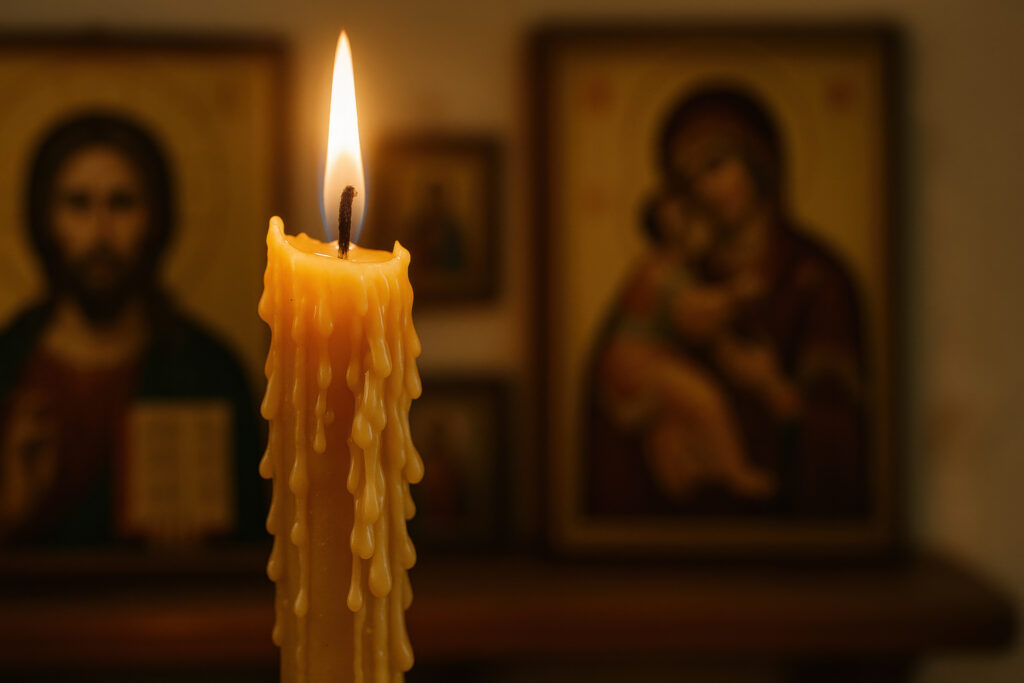 Candle burning in front of orthodox religious icons, symbolizing faith, spirituality, and sacred rituals in traditional worship